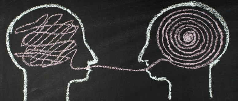Conversational intelligence. A chalk outline of two heads facing each other. The brain on the left contains a disorganized line. The line extends out the head's mouth and to the mouth of the head on the right. It then forms a spiral in the right head's brain.