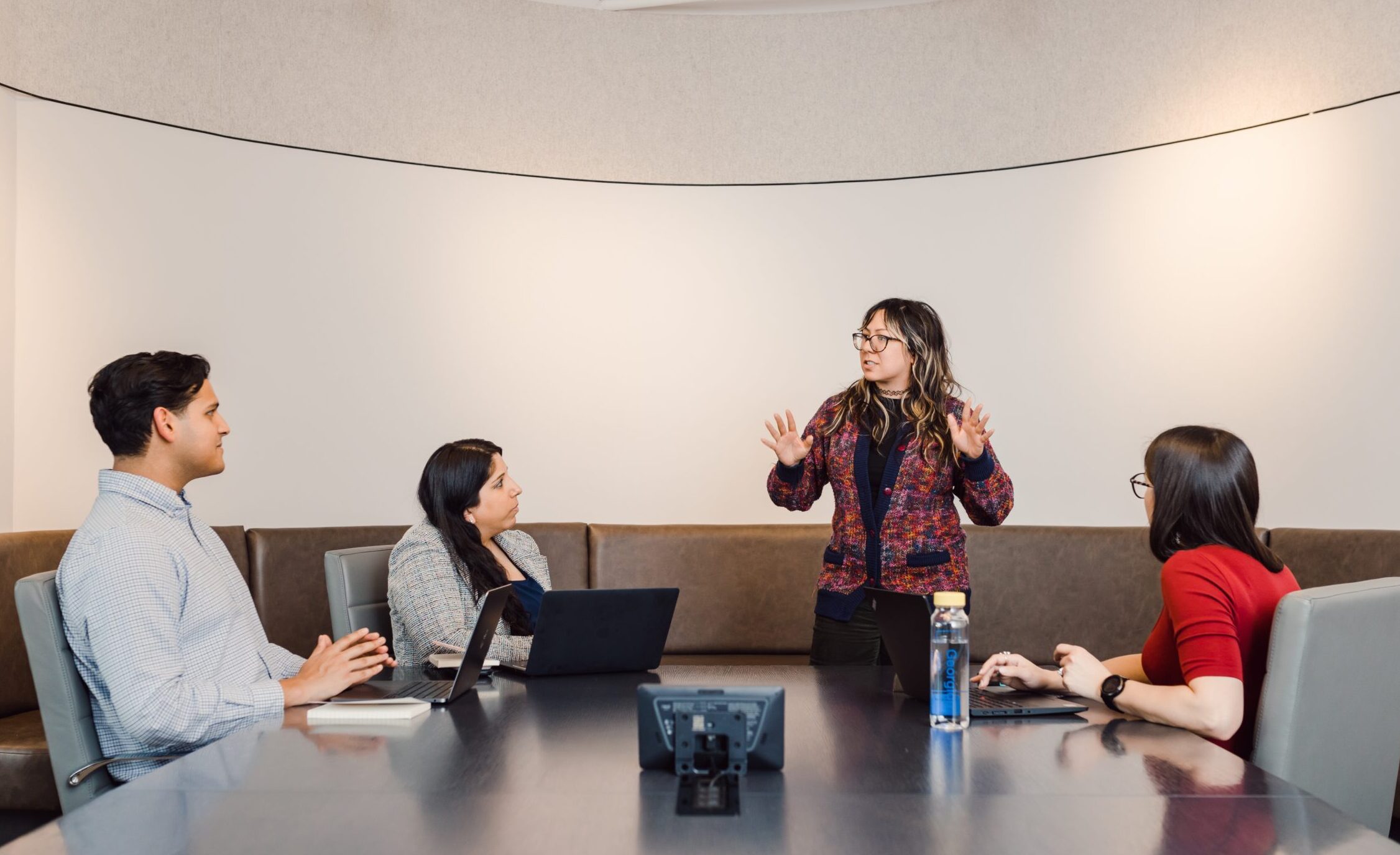 Employee leading a discussion with the team during a meeting